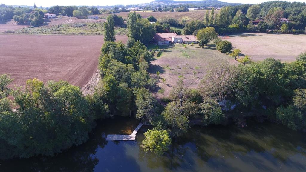 an aerial view of a river with trees and a house at GITES CLODEGUY No 2 in Saint-Sylvestre-sur-Lot