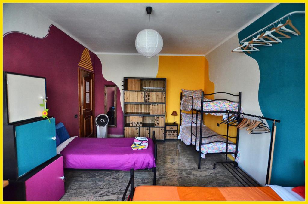 a bedroom with colorful walls and a bunk bed at WAOBAB - We are one B&B in Alzano Lombardo