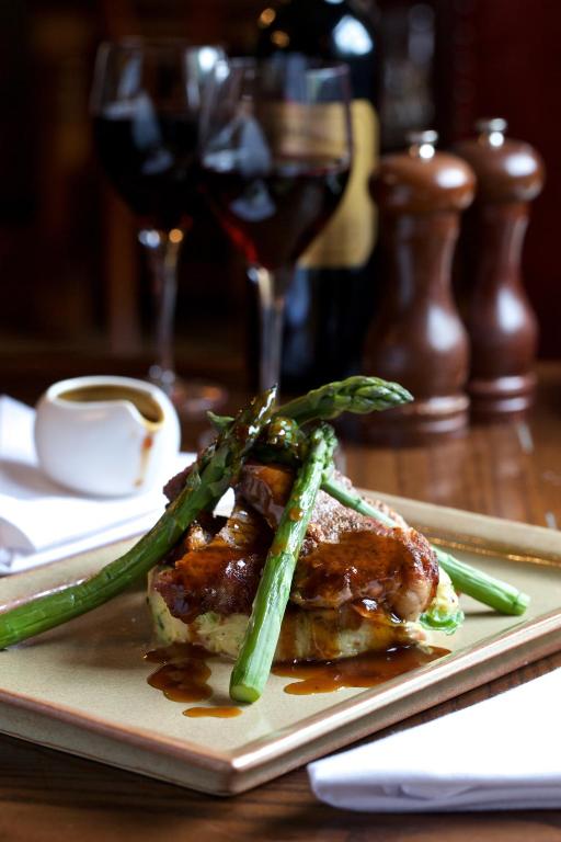 a plate of food with asparagus on a table at Victoria in Holkham