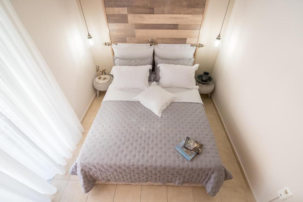 a bedroom with a large bed with two pillows at Comfort and Style in Preveza