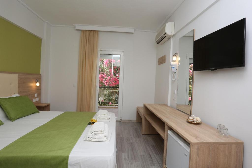 Posteľ alebo postele v izbe v ubytovaní Sun Hotel
