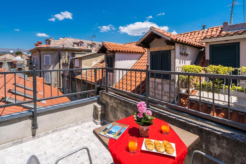 a balcony with a table with food on it at Rooftop city view apartment in the palace walls in Split