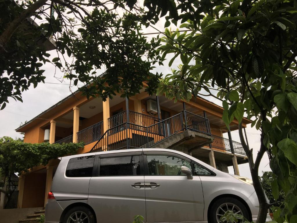a silver van parked in front of a building at Mahouse in Batumi