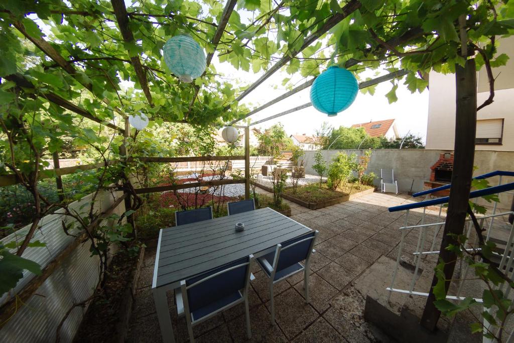 a patio with a table and chairs in a garden at Garden House in Ljubljana