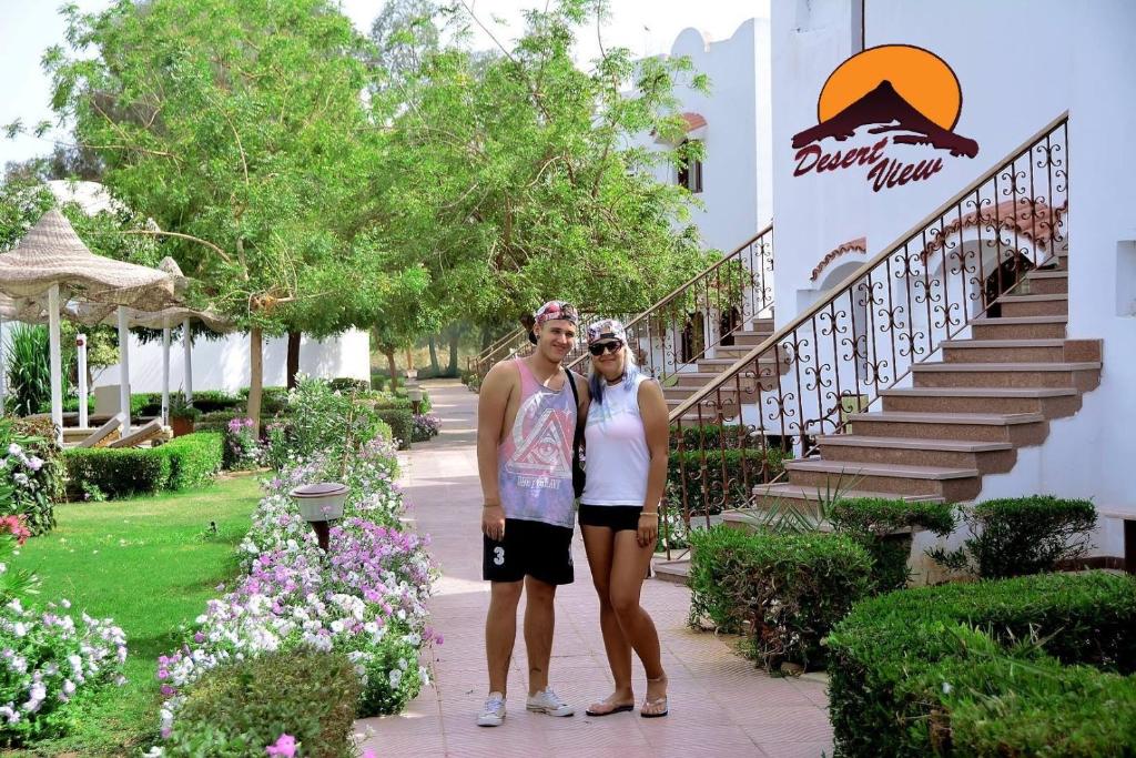 two people standing in front of a building at Desert View Sharm Hotel in Sharm El Sheikh