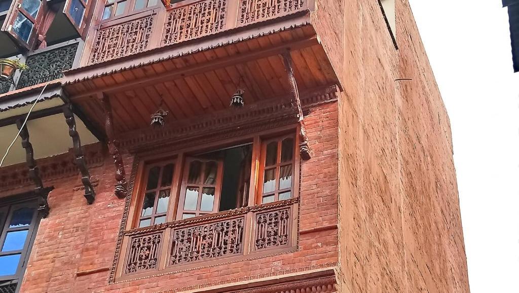 a wooden building with a balcony on top of it at Pottery Home in Bhaktapur