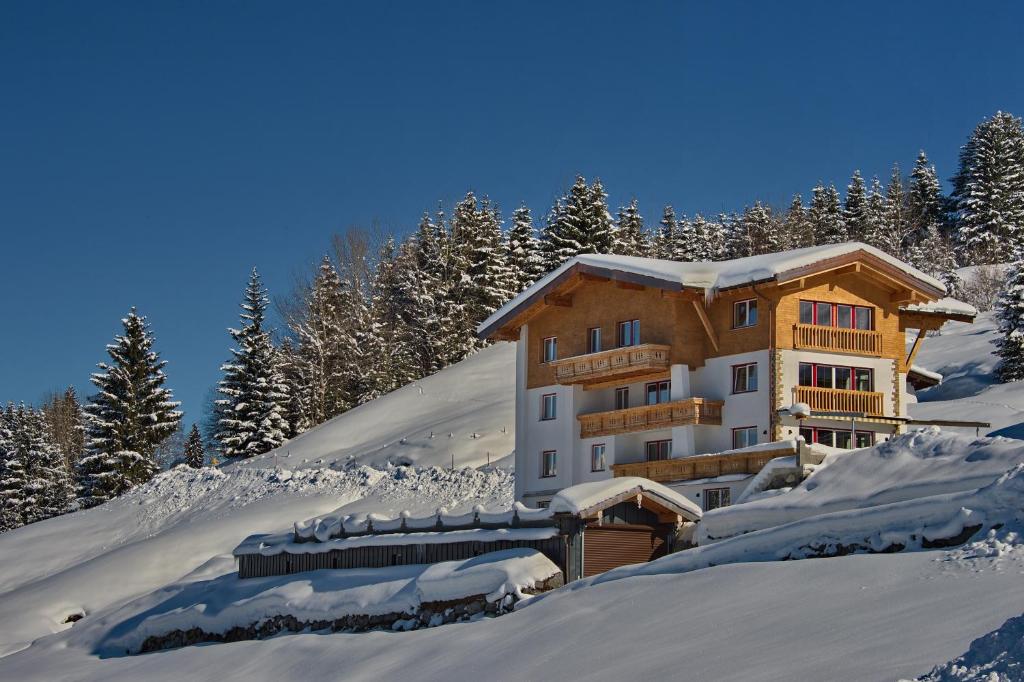 a building on top of a snow covered mountain at Ferien-Schlössle Michaela in Riezlern