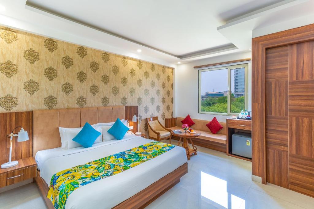 Postel nebo postele na pokoji v ubytování Inde Hotel Cyber City