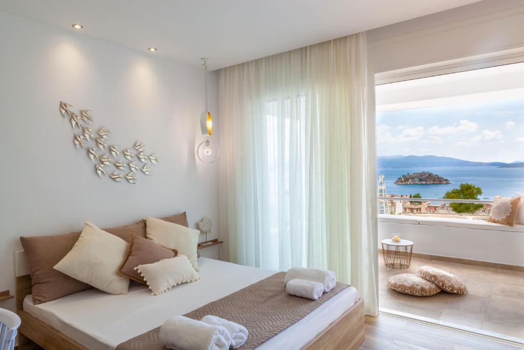 a bedroom with a bed with a view of the ocean at Elena's Tolo sea view in Tolo