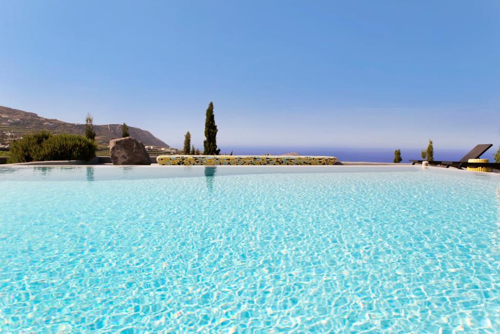 a large swimming pool with a view of the ocean at Christou Estate & Villas in Pyrgos