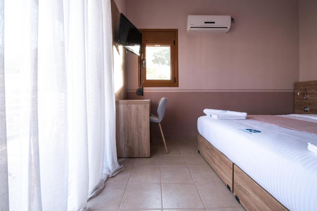 Postel nebo postele na pokoji v ubytování Cyrenia Guesthouse