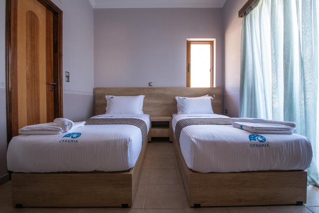 Postel nebo postele na pokoji v ubytování Cyrenia Guesthouse
