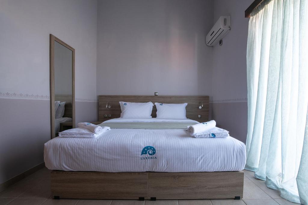 Postel nebo postele na pokoji v ubytování Cyrenia Guesthouse