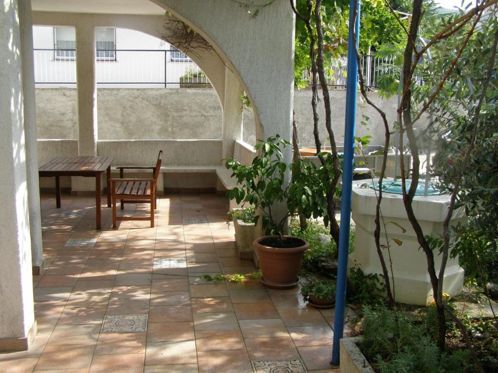 a patio with a table and a table and chairs at House Kaić in Selce