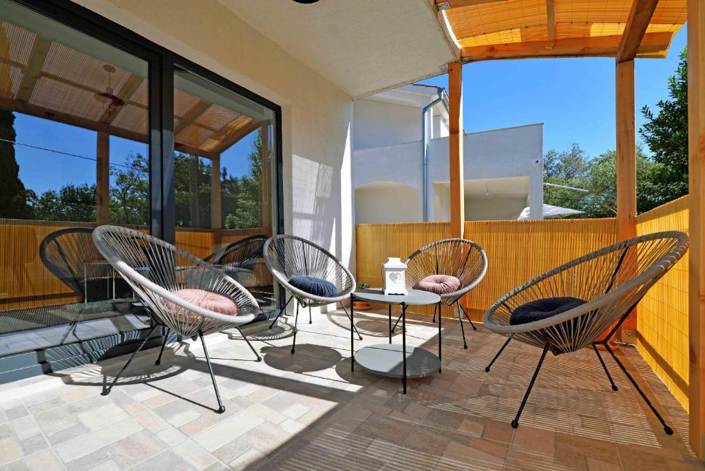 a patio with chairs and a table on a balcony at Holiday home Agata in Murter