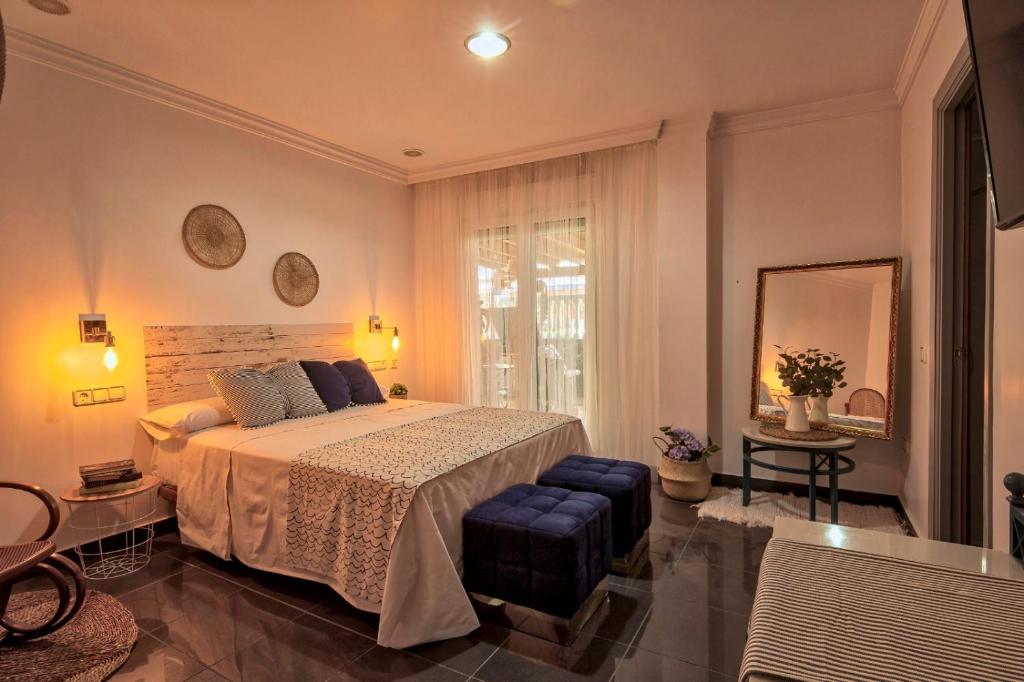 a bedroom with a bed and a large window at ROOMQUEO-Only Adults in Barbate