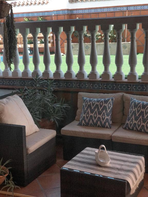 a balcony with a bench and a table with a heart on it at ROOMQUEO-Only Adults in Barbate