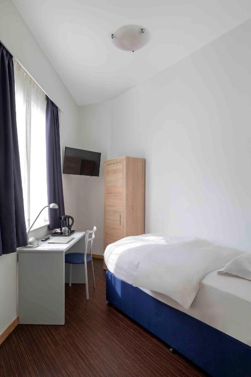 Postel nebo postele na pokoji v ubytování Hôtel Argus by happyCulture