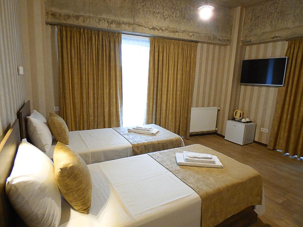 Postel nebo postele na pokoji v ubytování Magic Hotel