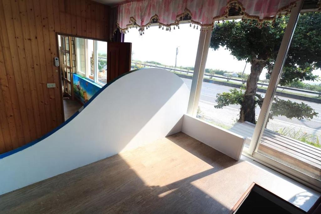 a skateboard ramp in a room with windows at Sunny Ocean B&amp;B in Yanliau