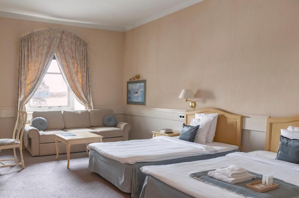 Postel nebo postele na pokoji v ubytování First Hotel Statt Örnsköldsvik
