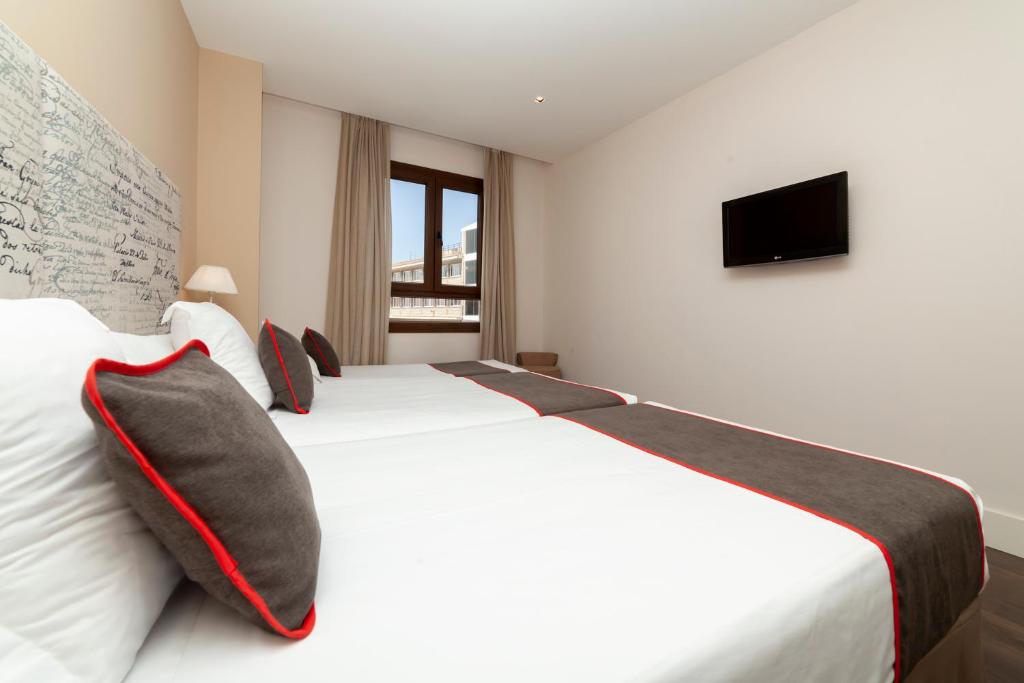 Televízia a/alebo spoločenská miestnosť v ubytovaní Hotel Altora