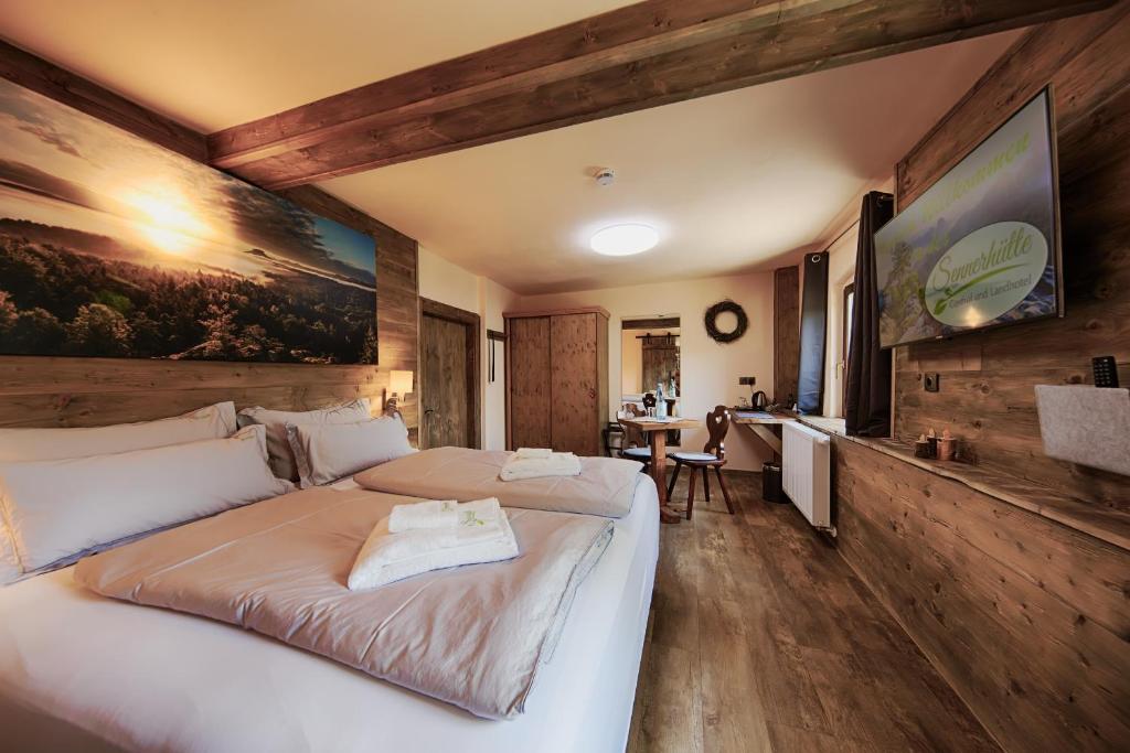 a bedroom with a large white bed in a room at Sennerhütte Landhotel in Kurort Gohrisch