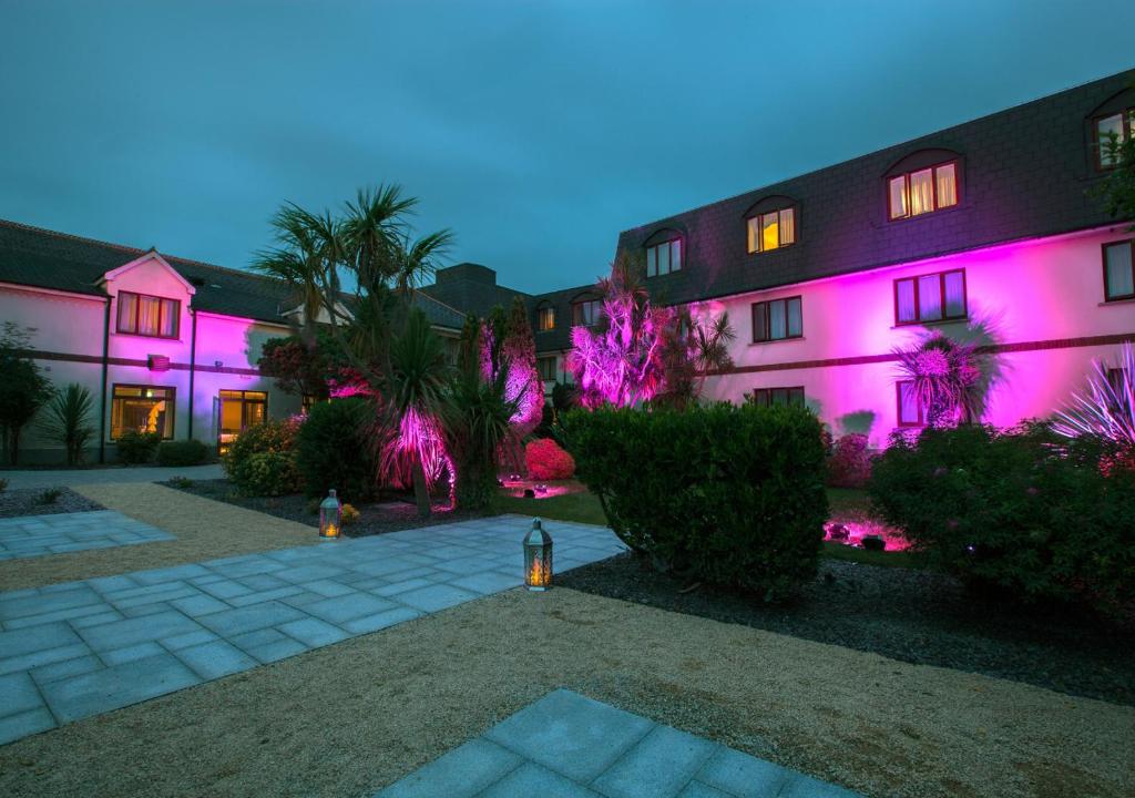 a building with pink lights on the side of it at Midleton Park Hotel in Midleton