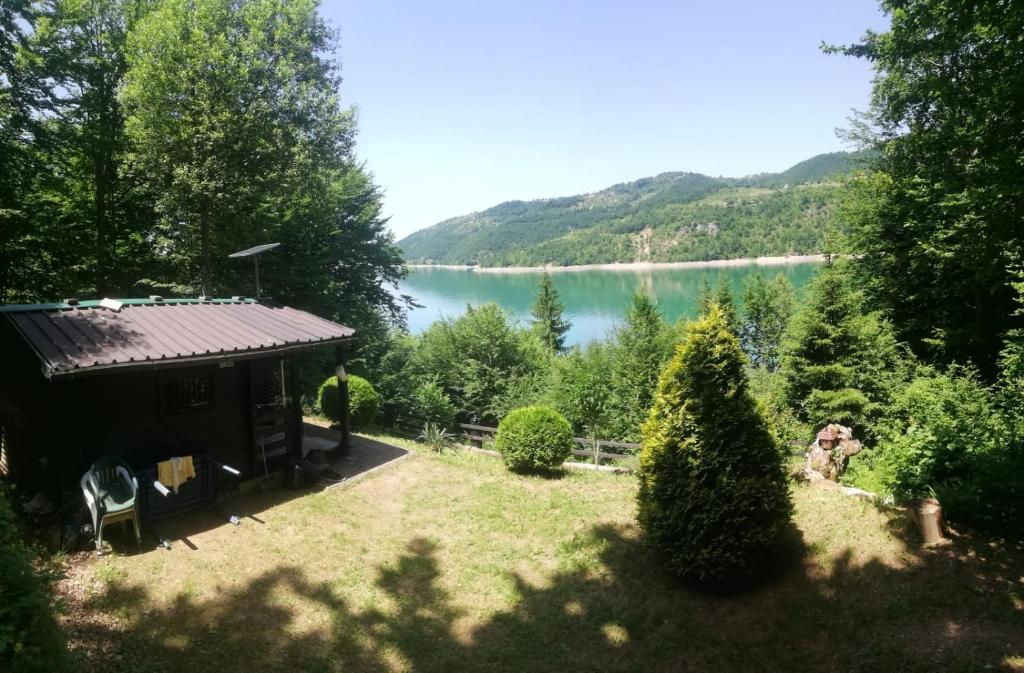 a small cabin with a view of a lake at Zlatar Lake - cottage in Kokin Brod