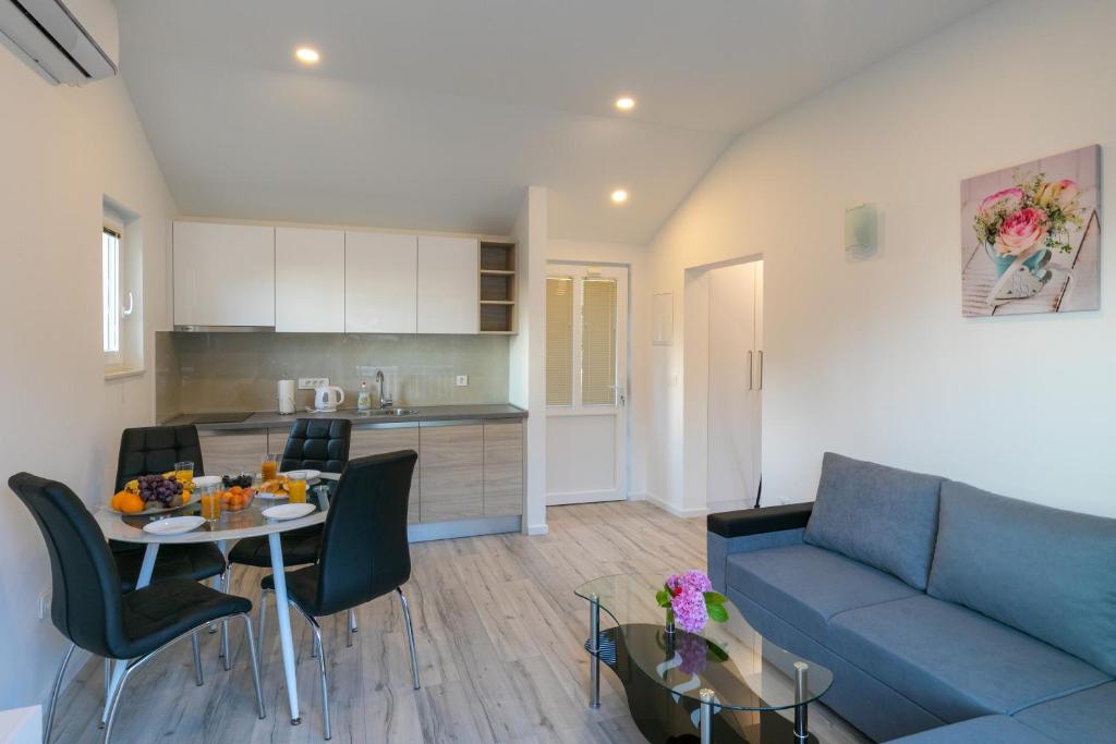 a living room with a couch and a table at Relax Zone Apartment in Trsteno