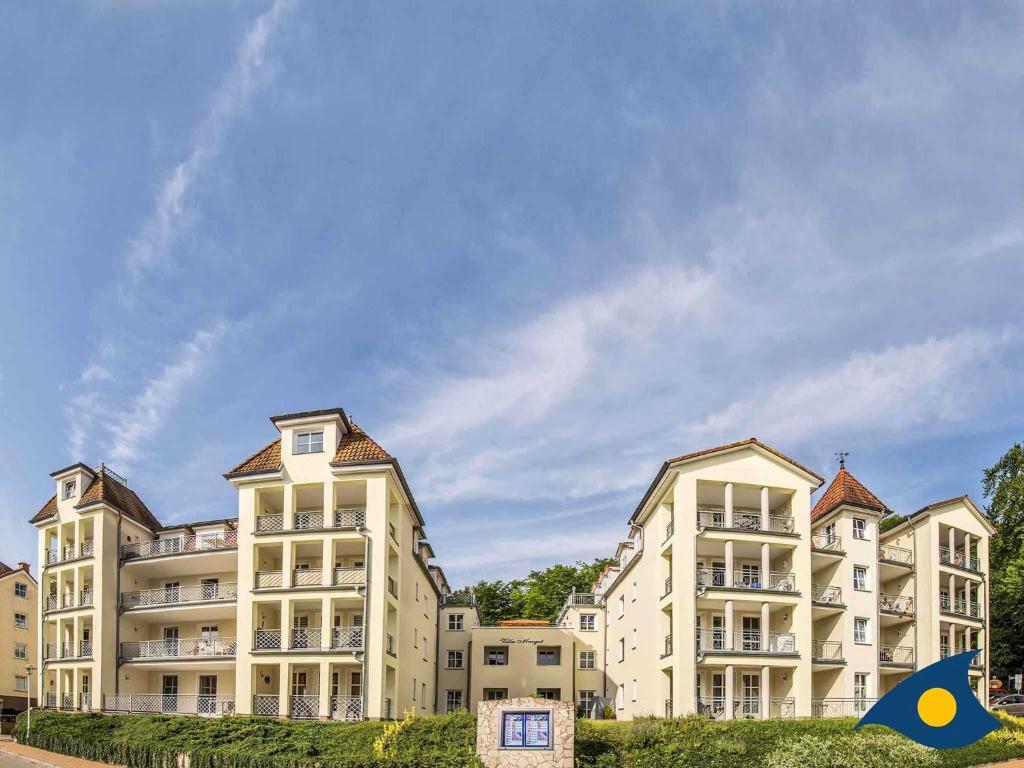 a large apartment building with a blue sky in the background at Villa Margot Whg 33 in Bansin