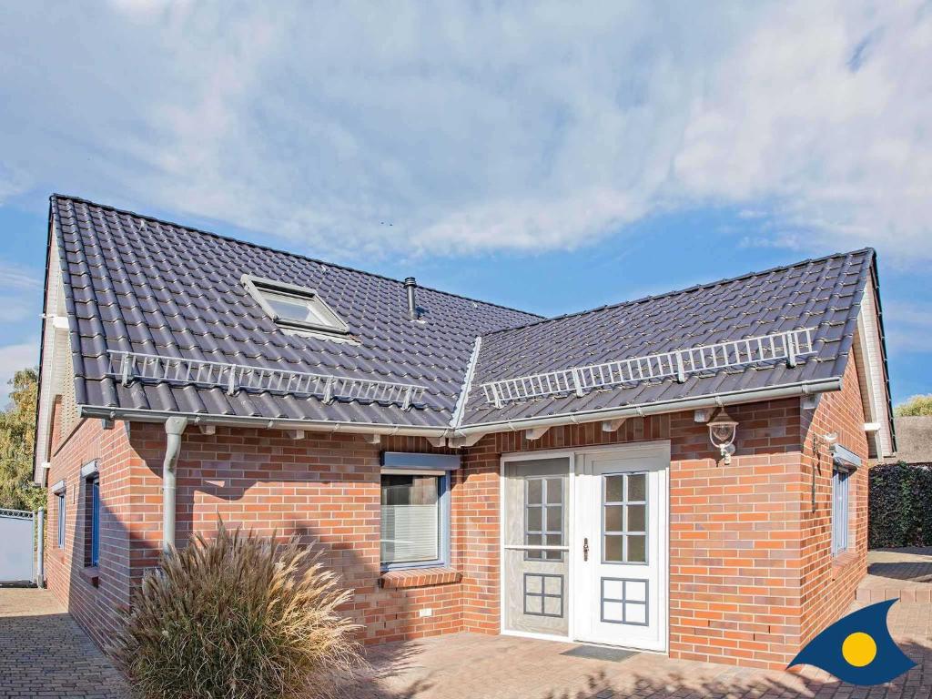 a brick house with a gray roof at Ferienhaus Melle 01 in Kolpinsee