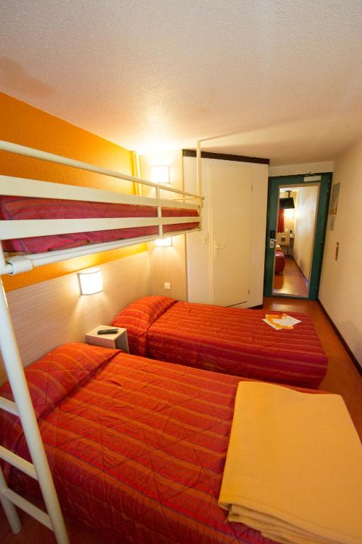 a bedroom with two bunk beds and a hallway at Premiere Classe Orleans Ouest - La Chapelle St Mesmin in La Chapelle-Saint-Mesmin