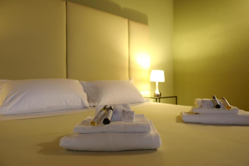 a hotel room with two towels on a bed at Osteria Luxury Apartments in Peschiera del Garda