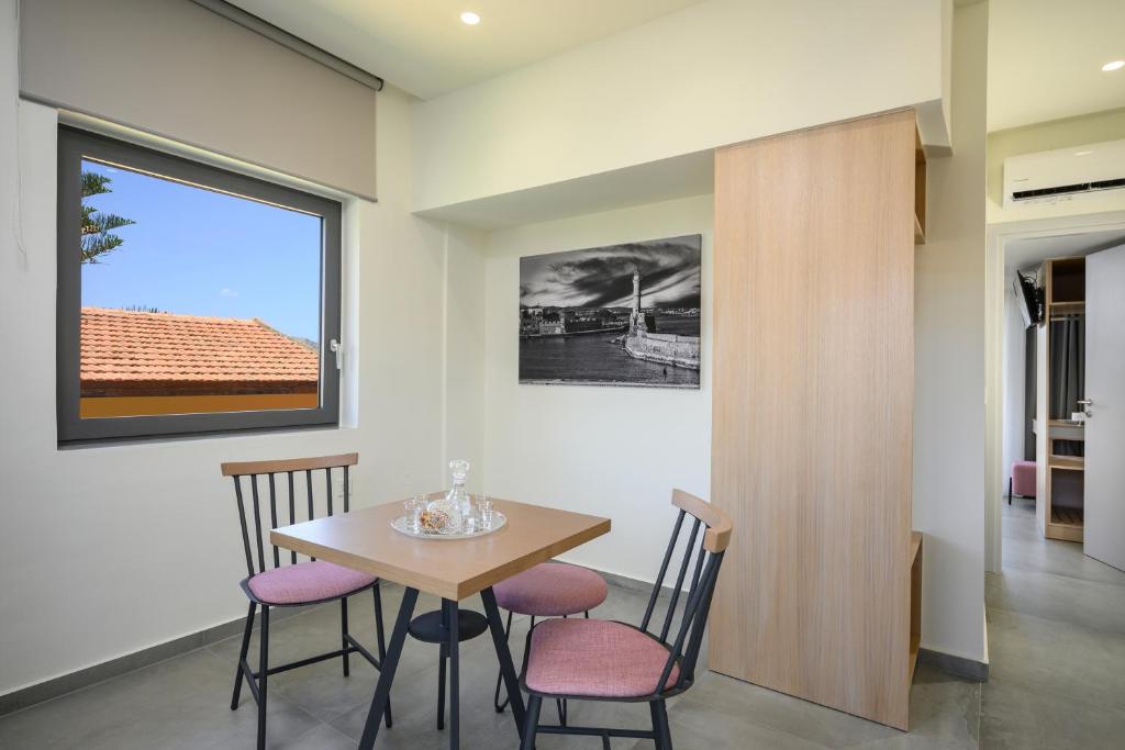 a dining room with a table and chairs at Athina Suites Luxury Suites Near The Sea Platanias in Platanias