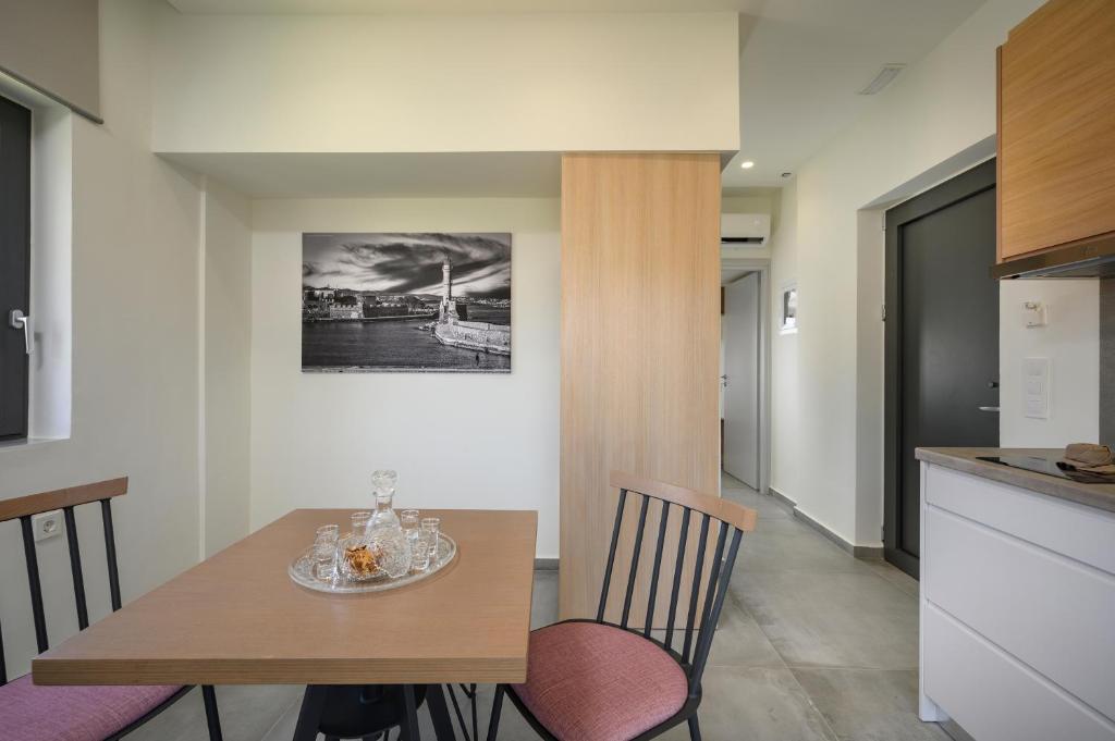 a kitchen and dining room with a table and chairs at Athina Suites Luxury Suites Near The Sea Platanias in Platanias