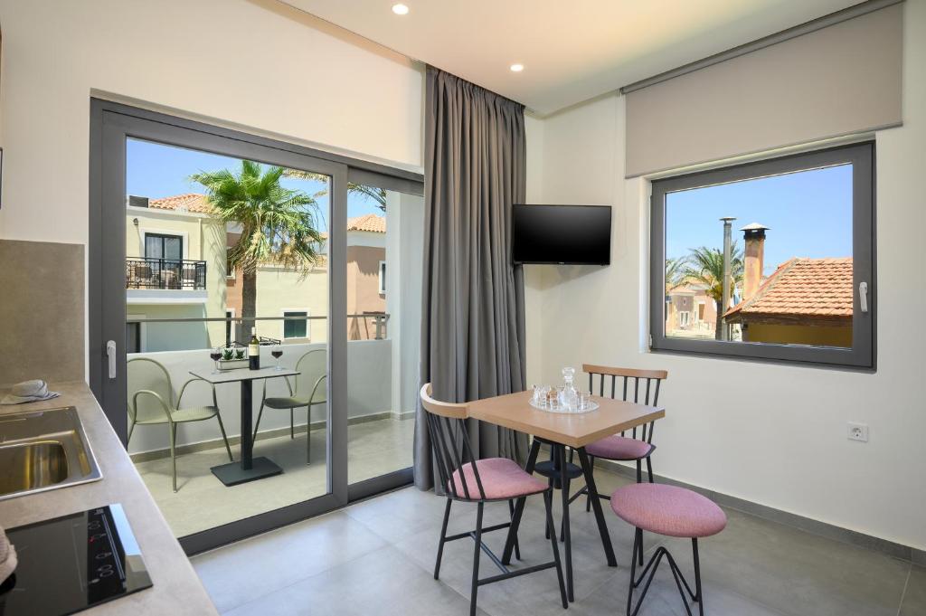 a kitchen and dining room with a table and chairs at Athina Suites Luxury Suites Near The Sea Platanias in Platanias