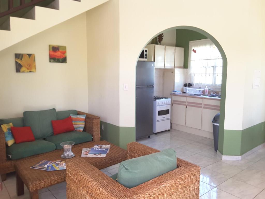a living room with a couch and a kitchen at SXM Spotters Paradise in Lowlands