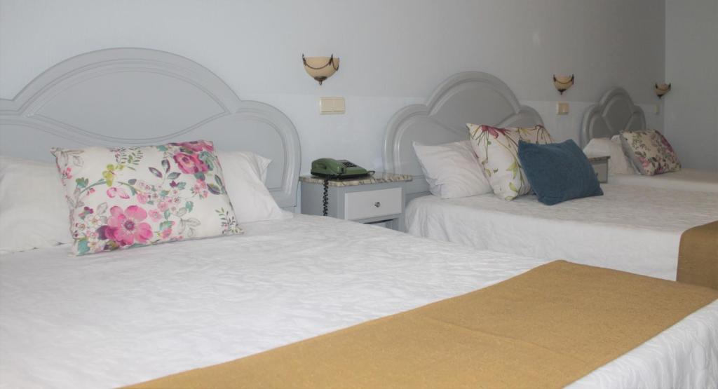 Postel nebo postele na pokoji v ubytování Residencial Clássico