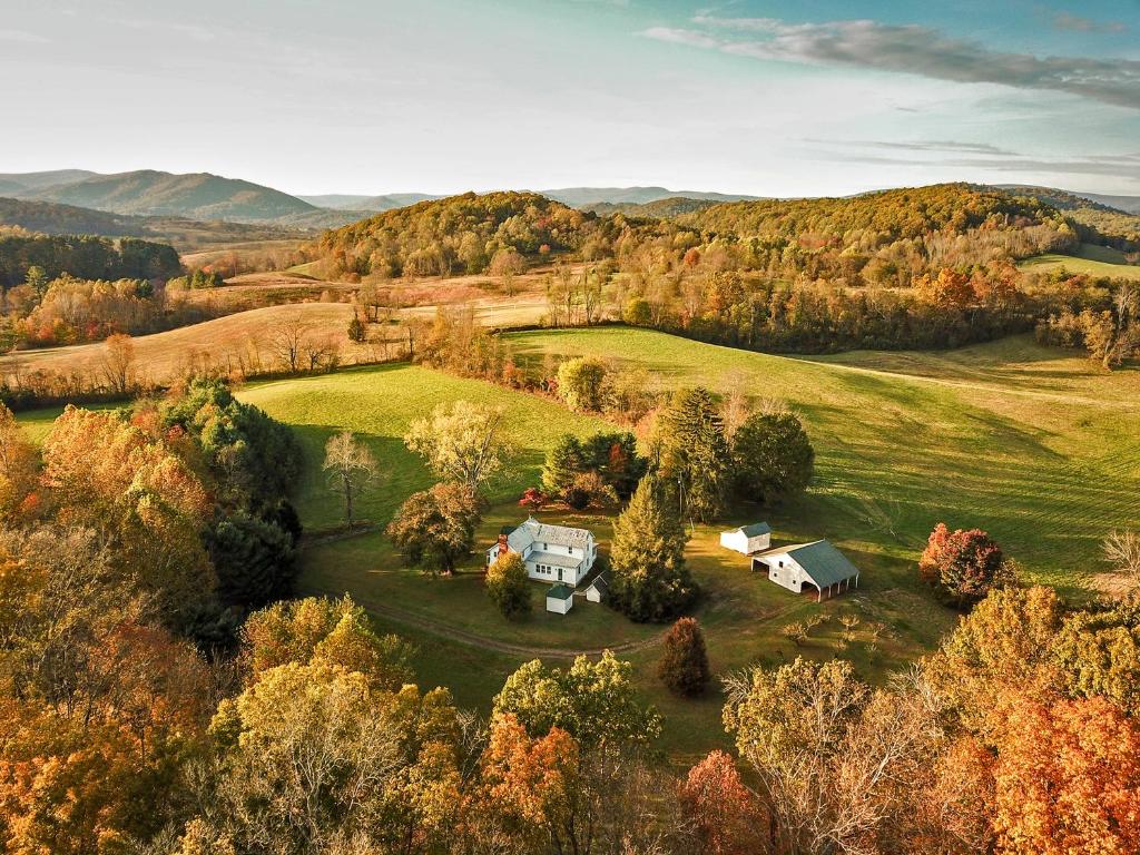 an aerial view of a house in the middle of a field at Walnut Run Farm in Woodville