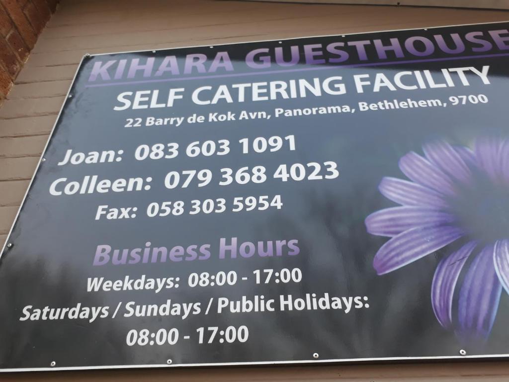 a sign for a self catering facility with a flower at KIHARA GUESTHOUSE in Bethlehem