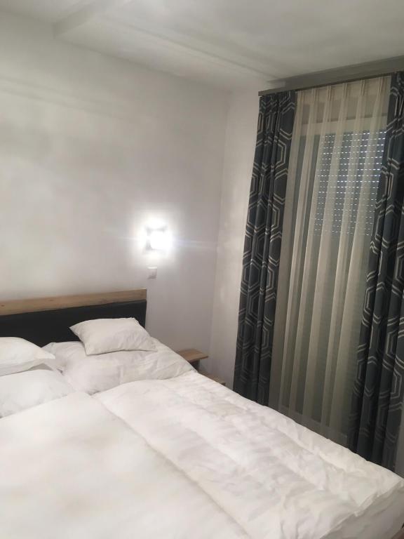 Postel nebo postele na pokoji v ubytování SUN-DIAL APARTMAN