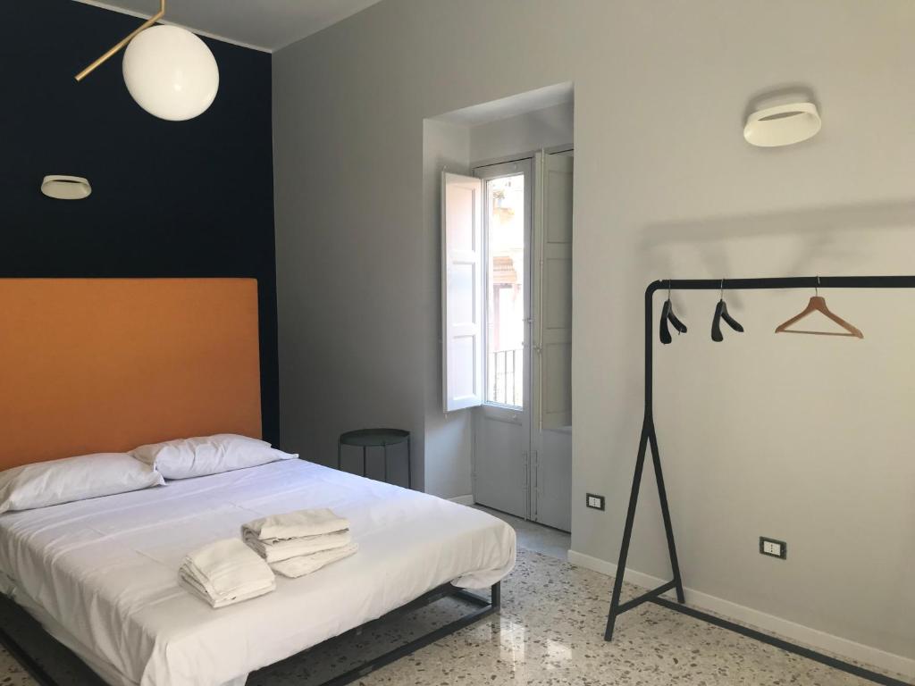 a bedroom with a bed with two towels on it at Dimora San Camillo in Catania