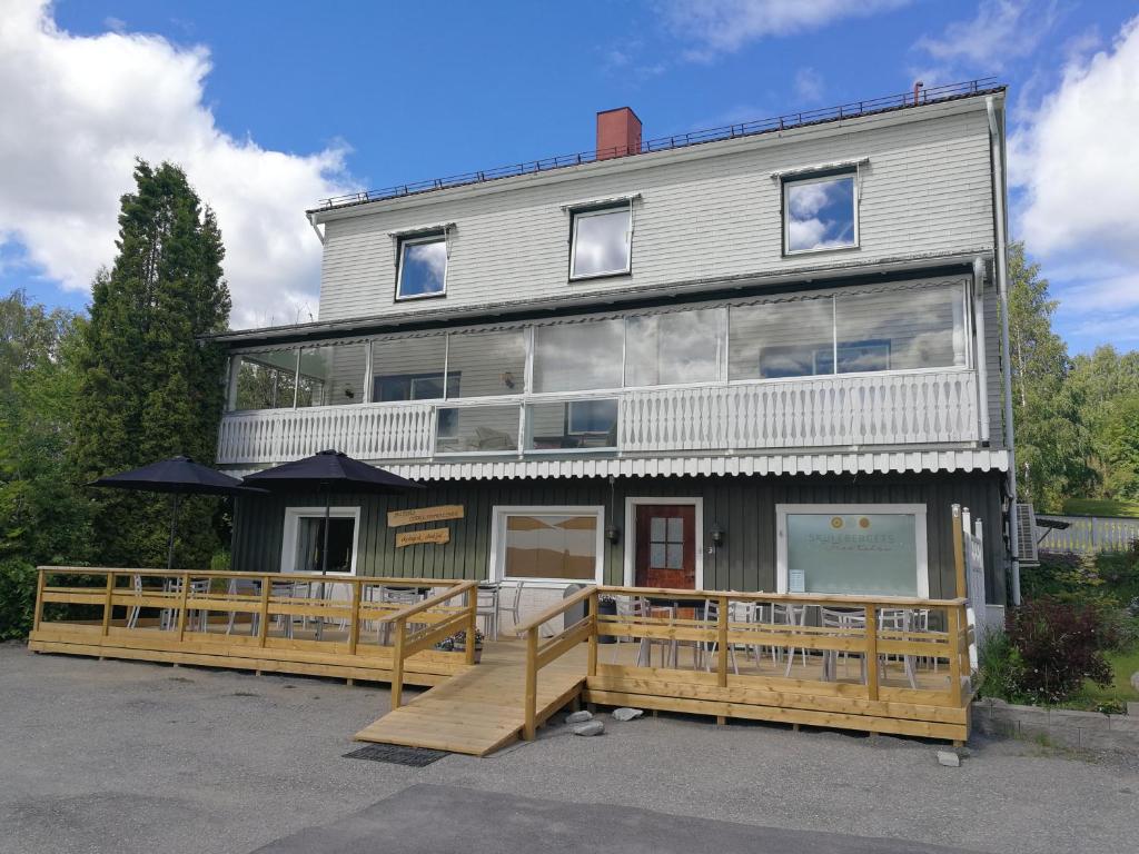 a large house with a wooden ramp in front of it at Skulebergets Frestelse in Docksta