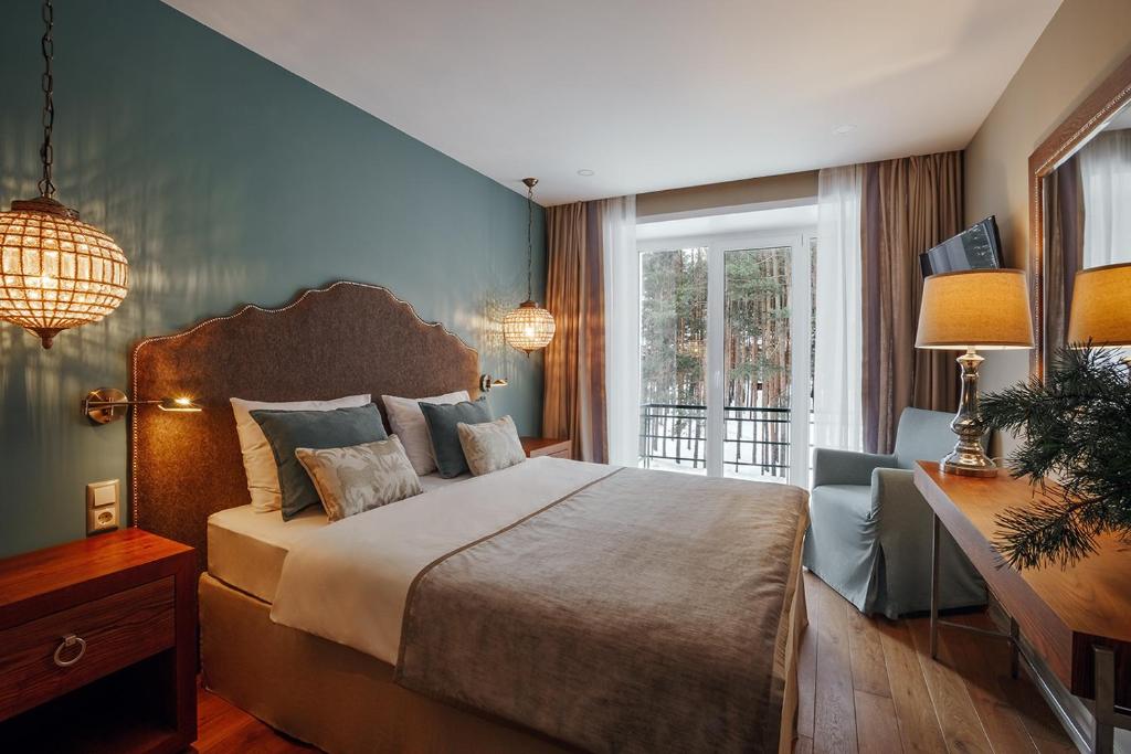 a bedroom with a large bed and a window at Vania Rooms Hotel in Vladimir