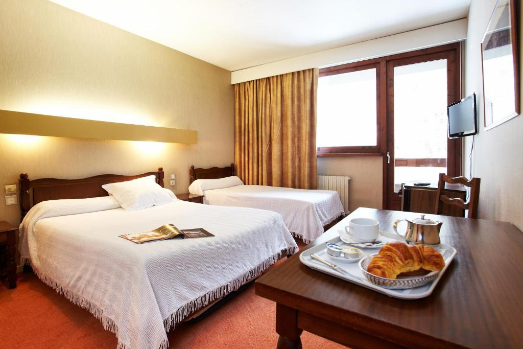 Uma cama ou camas num quarto em Hôtel de Paris
