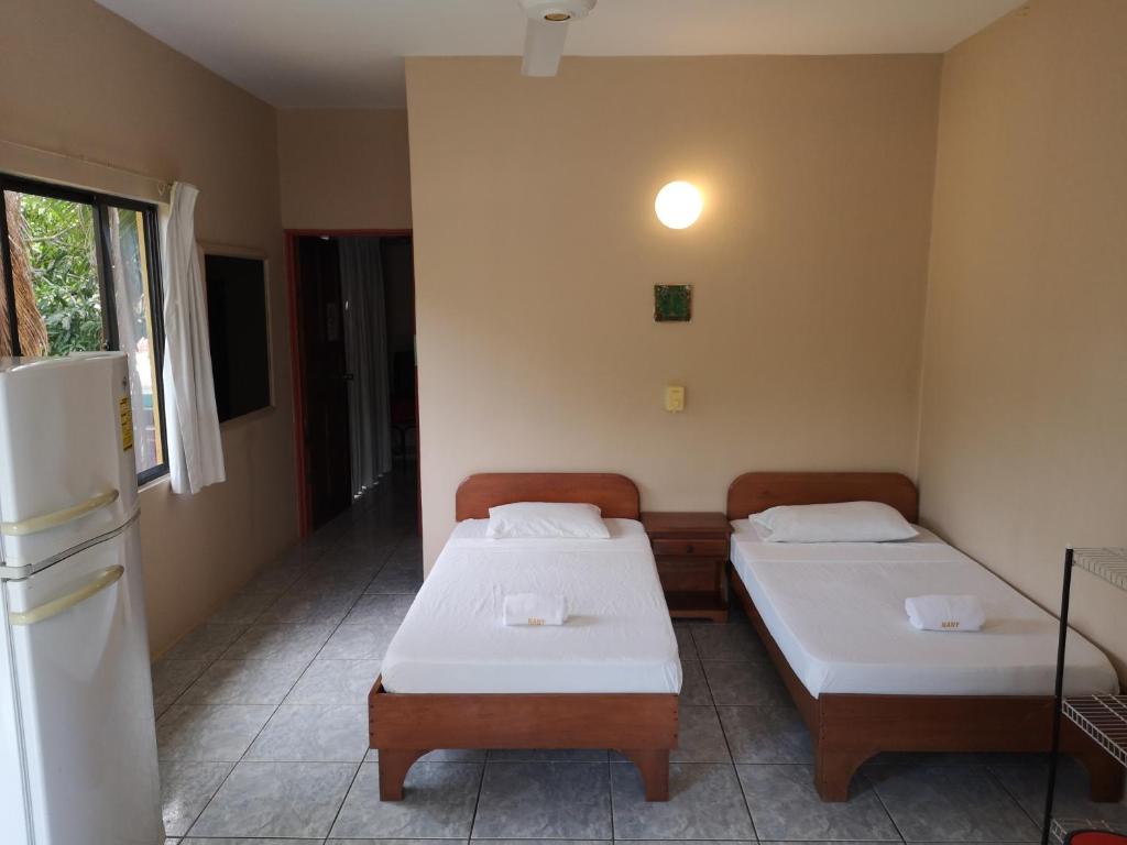 Postel nebo postele na pokoji v ubytování Hotel Nany