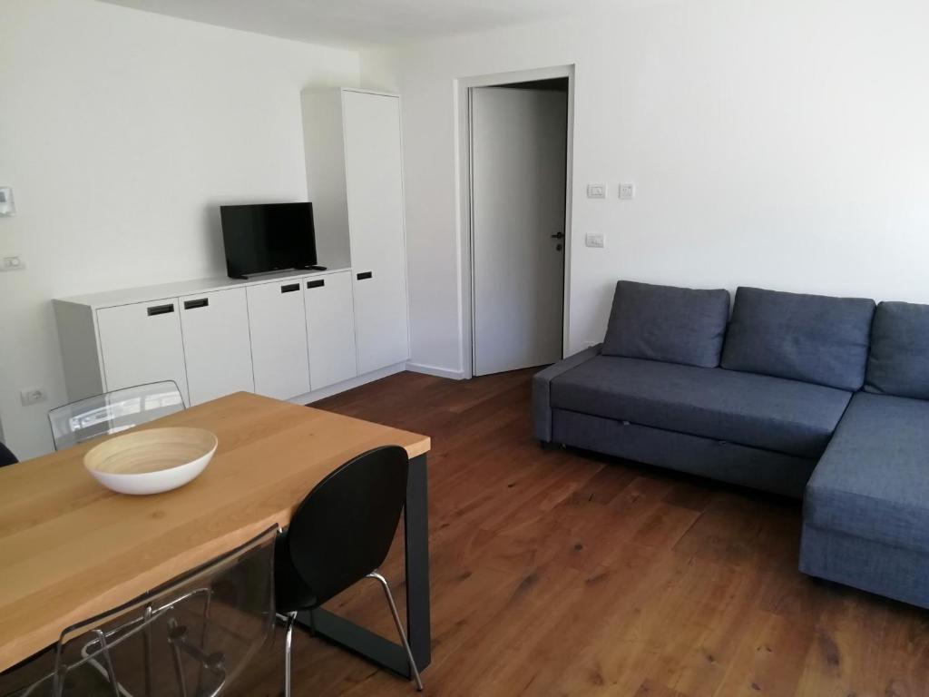 a living room with a blue couch and a table at Fewo Paul in Bressanone