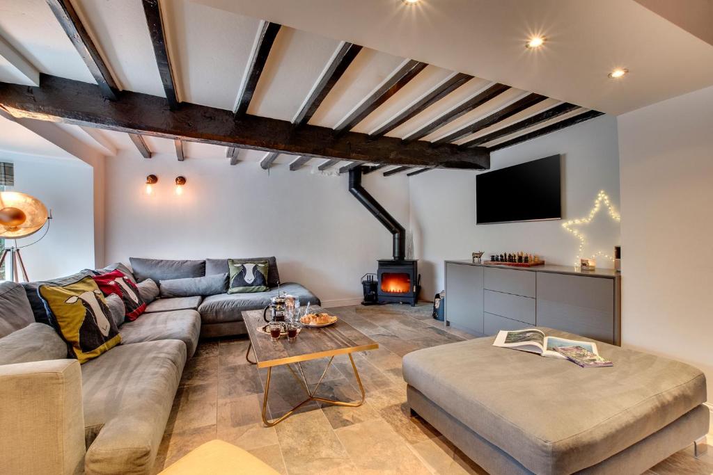 a living room with a couch and a table at Aysgarth Nook by Maison Parfaite - Luxury Holiday Home with Hot Tub in Aysgarth