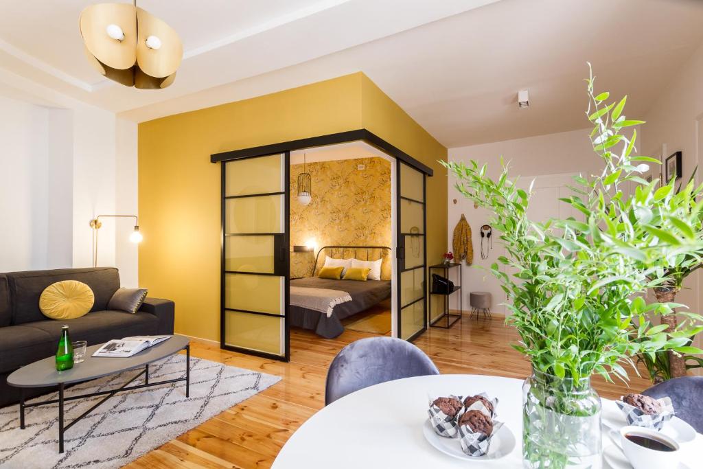 a living room with a couch and a table at House Apartments Centrum Poznań in Poznań